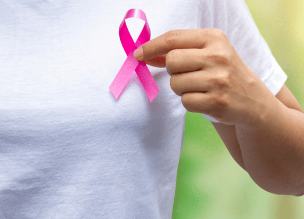 a women holding pink ribbon 🎗 