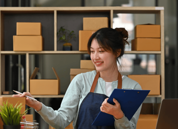 a girl holding pen and board doing work 