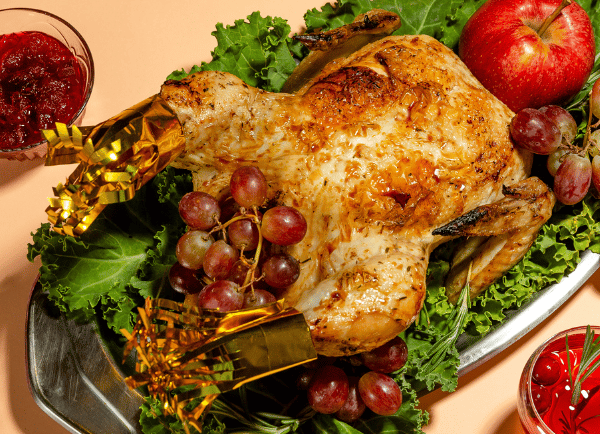rosted turkey with fresh fruits and vegetabes on the table