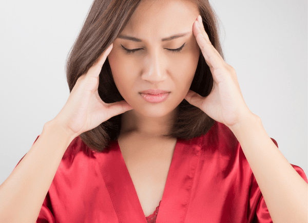 a women  holding her head 
