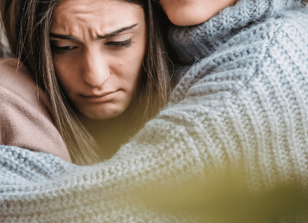 two womens hugging 