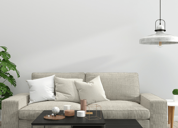 a room with Creem color sofa and table and lamp
