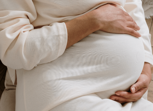 a pregnant women wearing white t-shirt 