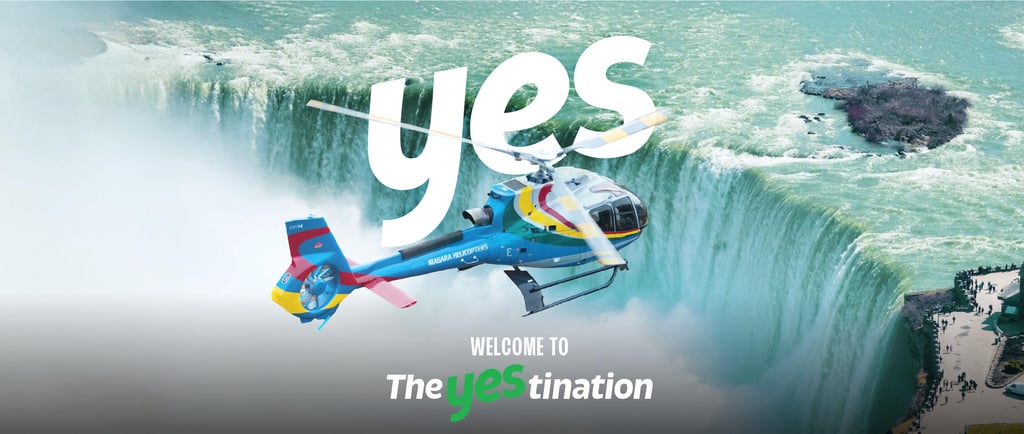 A colorful sightseeing helicopter flying over the rushing water of Niagara Falls.