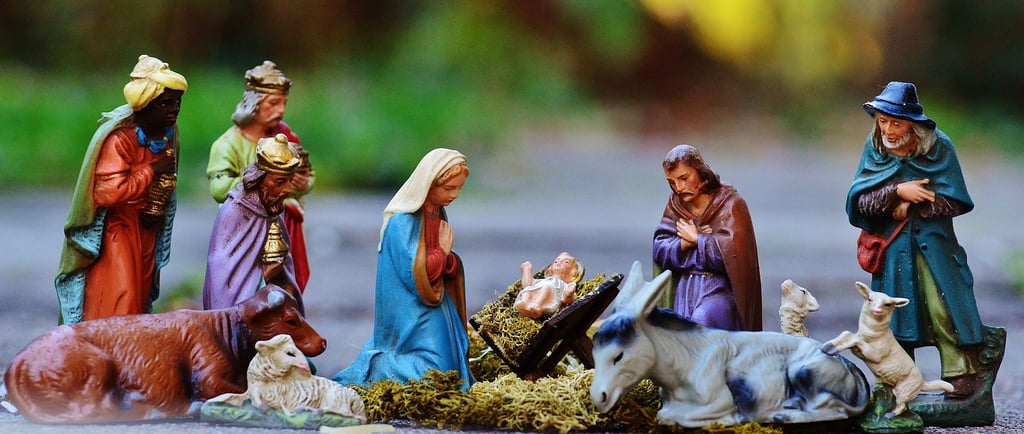 Figurines of nativity including Baby Jesus, characters, and animals