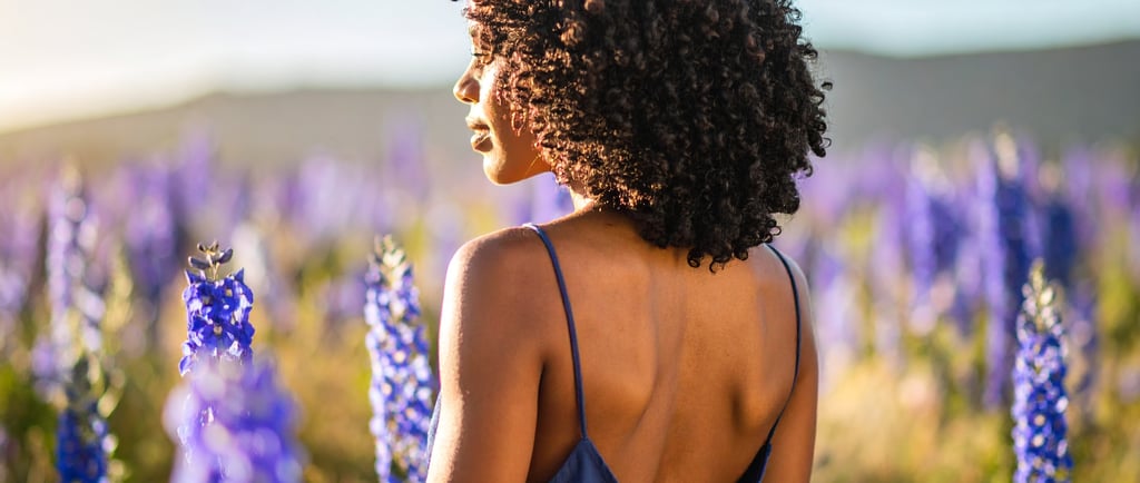 black woman in a field full of larkspur