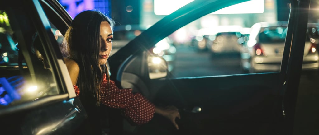 a woman in a polka dot dress sitting in a car