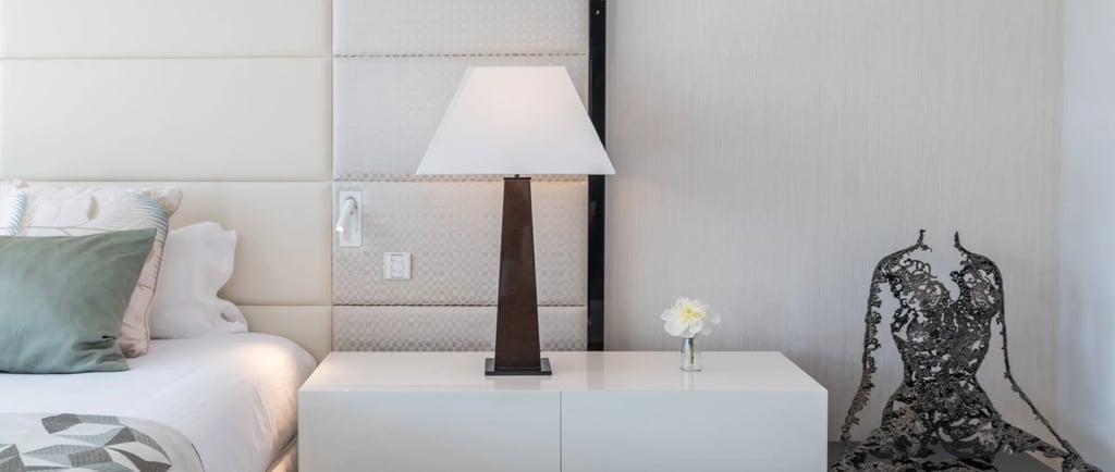 Modern bedside table with lamp and sculpture at Villa Serenity