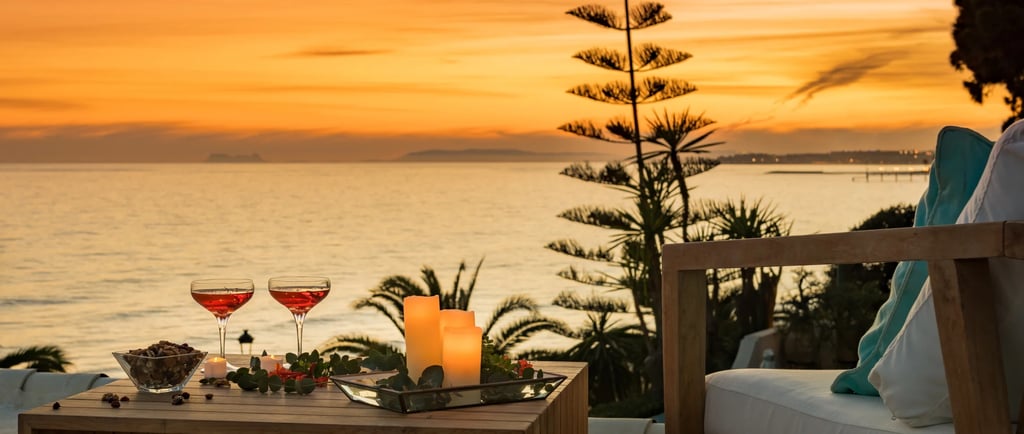 Sunset terrace with cocktails and candles overlooking the coastline