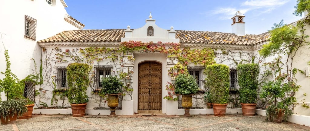 Historic Andalusian courtyard with tiled fountain and potted plants