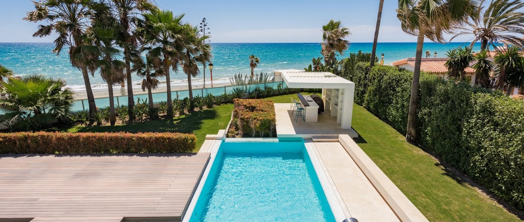 Beachfront pool and garden with outdoor bar pavilion