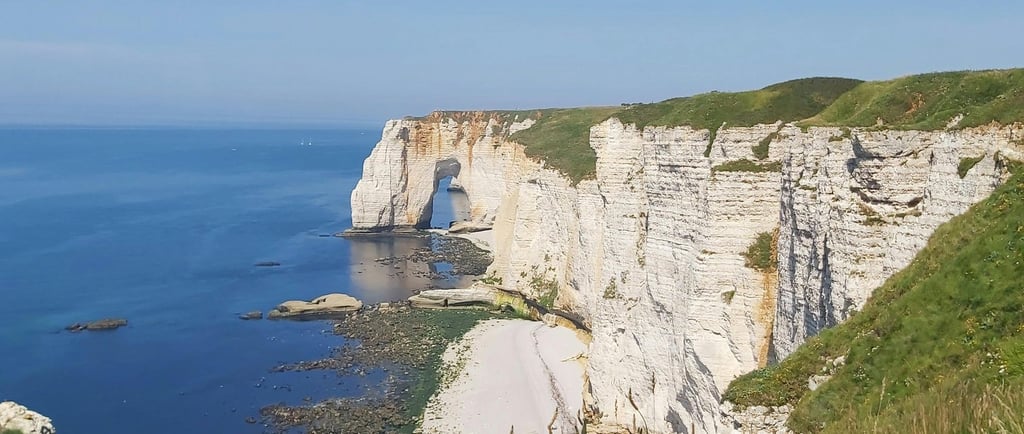 a person standing on a cliff overlooking the ocean
