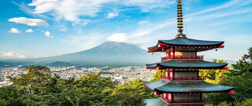 a pagoda in the mountains with a mountain in the background