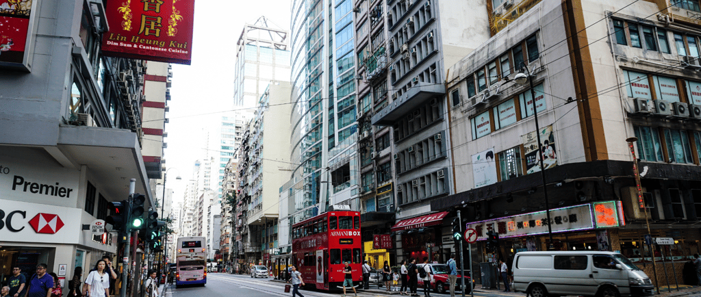 Rua movimentada no centro de Hong Kong durante o dia.