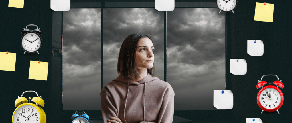 a woman standing in front of a window with a clock