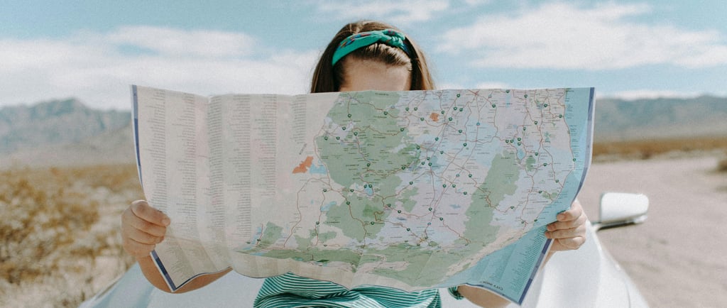 a woman holding a map of a map of a map of the world