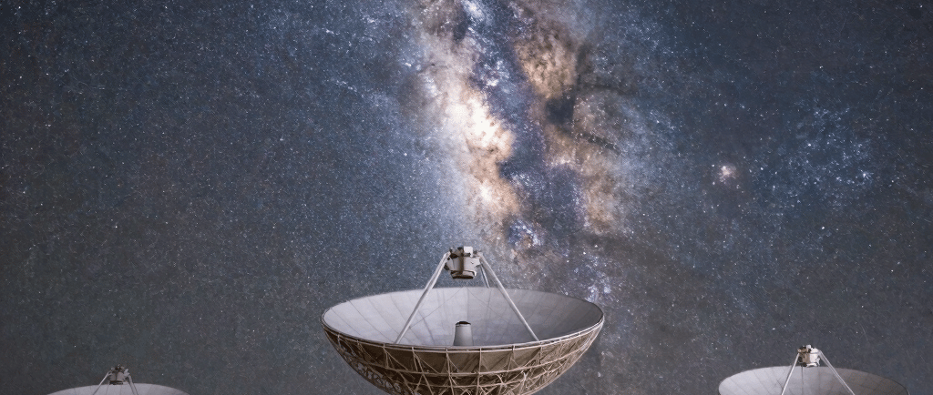 Large radio telescope antennas pointed at the vibrant Milky Way galaxy in a starry night sky.