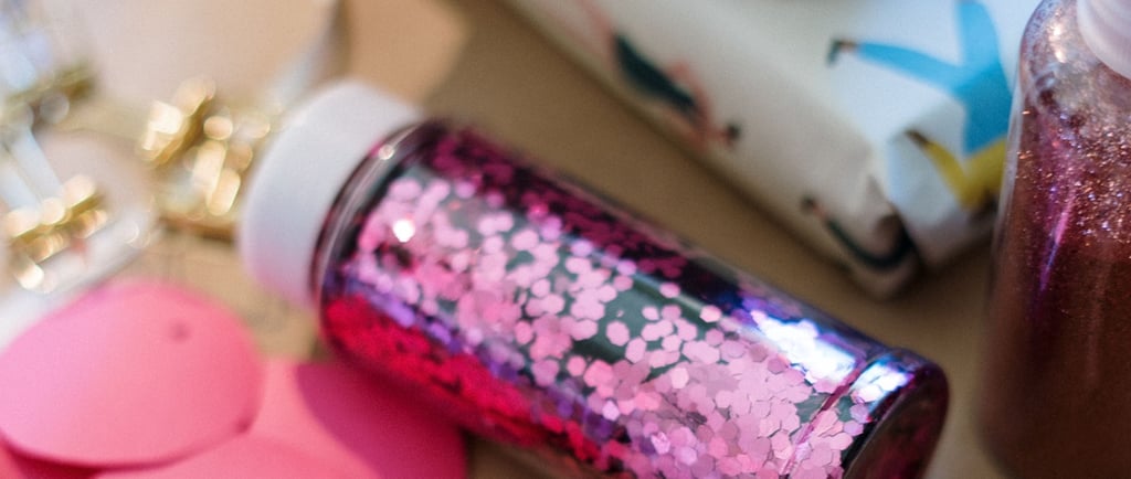 A jar of pink hexagonal glitter for DIY crafts and gift wrapping projects.