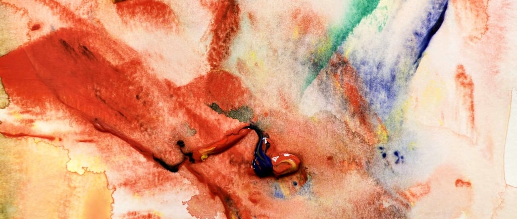 Abstract watercolor painting featuring vibrant red, blue, and green strokes on textured paper.
