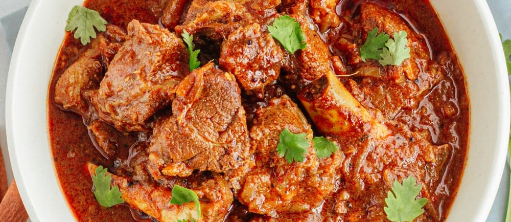 Homemade mutton curry made with fresh goat meat – easy Indian recipe for beginners.