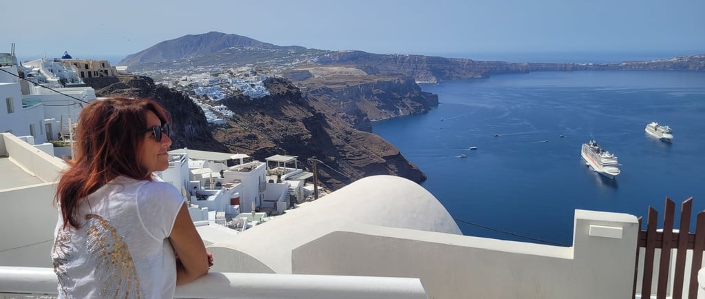 a french sommeliere standing on a balcony at santorini