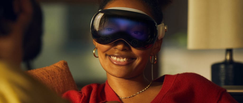 a woman wearing a red sweater and Apple VR