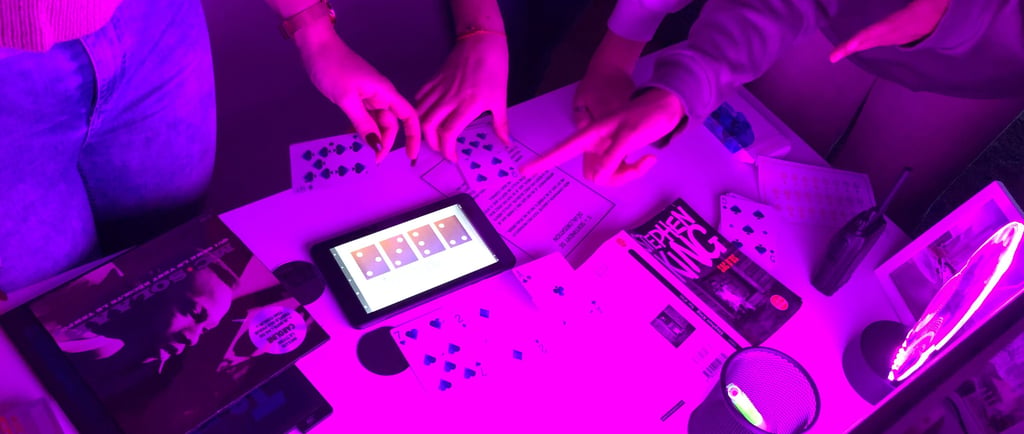 Friends solve puzzles at an immersive escape room table illuminated by neon purple light.