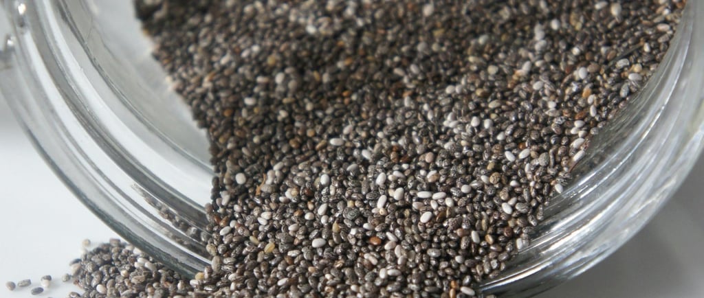 Chia seeds in a glass jar with a spoon, showcasing their potential to support healthy weight loss.