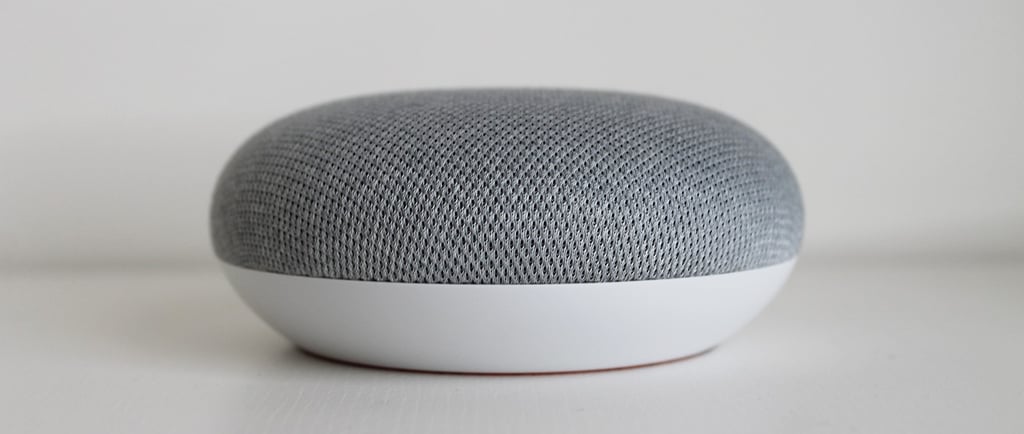 a google homepod speaker with a grey and white background