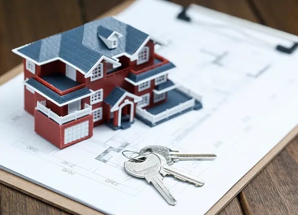 a house with keys and keys in front of a clipboard