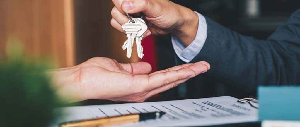 a person holding a keychaik in their hand