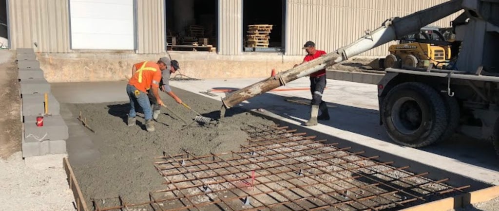 a man is pouring concrete into a concrete slab