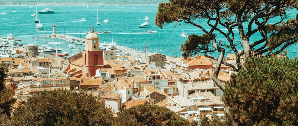 View of Saint-Tropez with traditional houses, the bay, boats and luxury yachts on the French Riviera