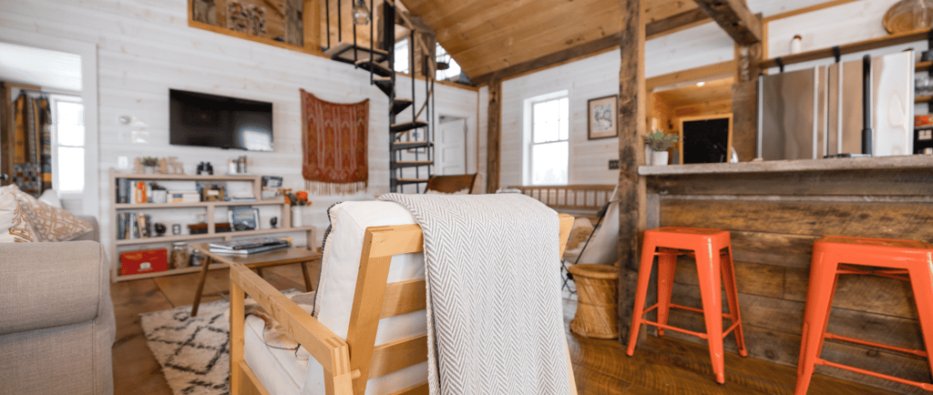 a living room with a couch and a bar stool