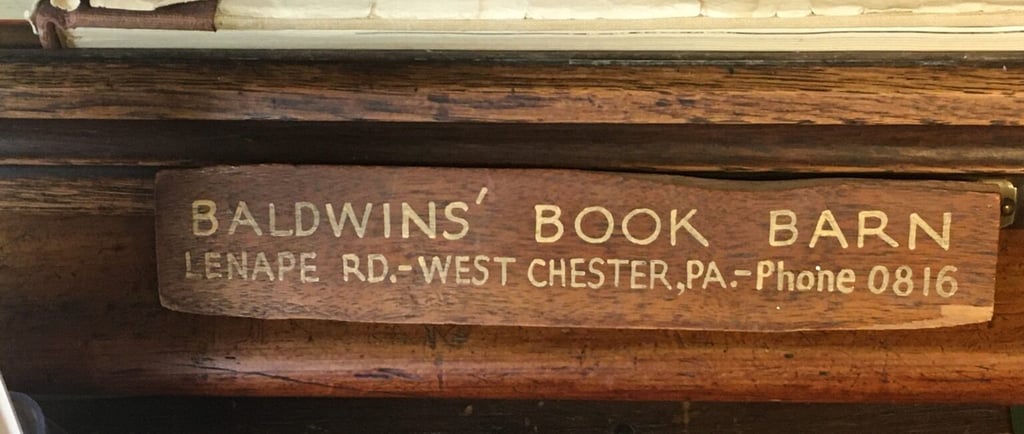 a wooden sign that says Baldwins book barn, and a picture of a book barn sign