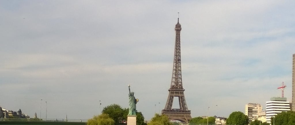 a view of a city with a tower in the Paris background