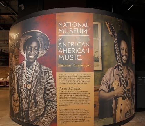 a large display of a man in a hat and a guitar