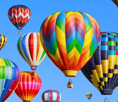 a bunch of colorful balloons in the sky
