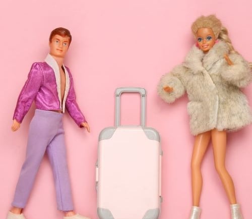 a couple of dolls are standing next to each other