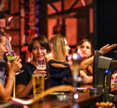 a group of people sitting at a bar