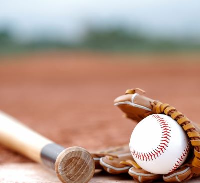 a baseball bat and a baseball glove on a baseball field