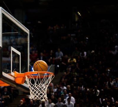 a basketball player is about to dunk the ball