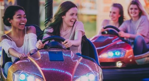 a group of friends enjoying a ride on a bumper car