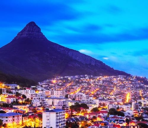 a cityscape of a mountain with a mountain in the background