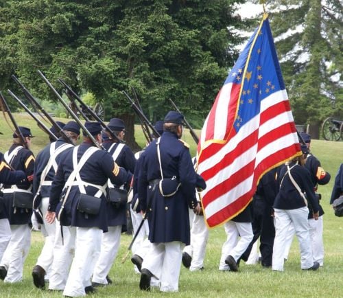 a group of men and women in uniform uniforms holding flags