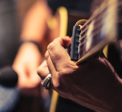 a man playing guitar in a recording studio