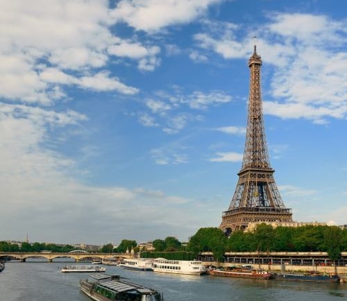 a boat on the river with a view of the eiffel tower
