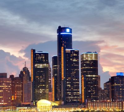 a city skyline with skyscrapers and a river in the foreground