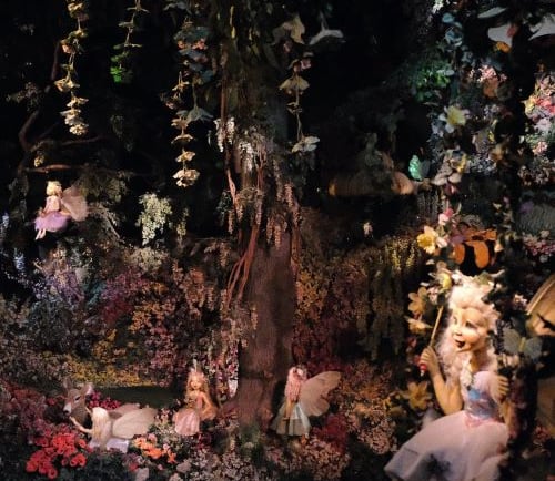 a display of fairy - themed items in a display case