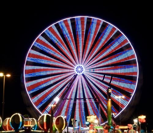a ferris wheel with a ferris wheel in the middle of a night